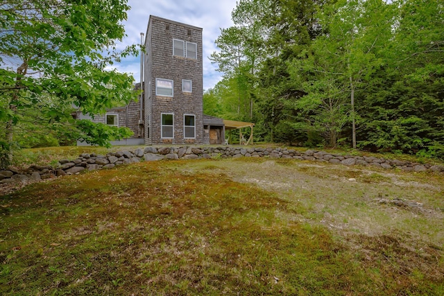 38 Johnson Cove Rd, Otis, ME 04605 - back of house with a lawn and stone siding