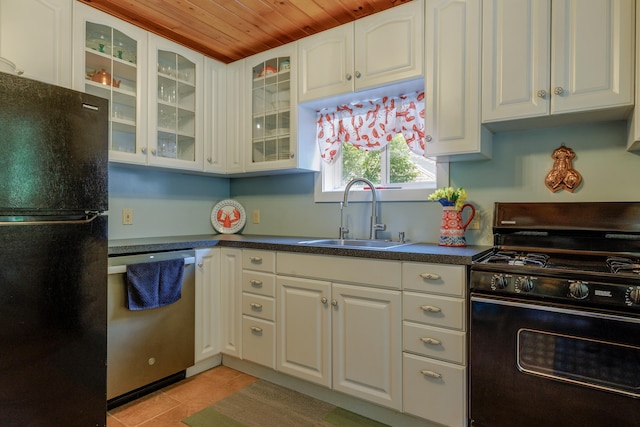 38 Johnson Cove Rd, Otis, ME 04605 - kitchen with black appliances, wood ceiling, white cabinetry, dark countertops, and glass insert cabinets