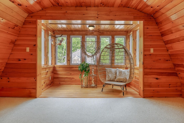 38 Johnson Cove Rd, Otis, ME 04605 - sitting room with vaulted ceiling, wood walls, wooden ceiling, and carpet