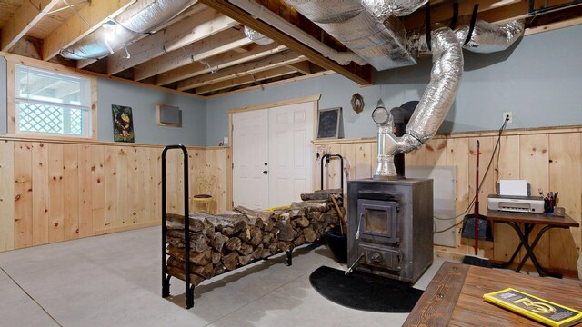 580 Spring St, Brownfield, ME 04010 - basement with a wood stove, wood walls, and wainscoting