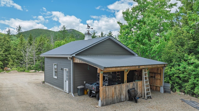 580 Spring St, Brownfield, ME 04010 - garage featuring driveway, a mountain view, and a view of trees