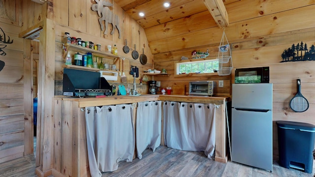 580 Spring St, Brownfield, ME 04010 - kitchen featuring freestanding refrigerator, wooden walls, wood finished floors, black microwave, and wooden ceiling