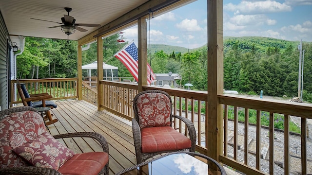 580 Spring St, Brownfield, ME 04010 - wooden terrace with a ceiling fan, a wooded view, and a mountain view