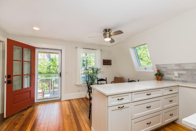21 Fernald Ave Unit B, York, ME 03909 - kitchen with a peninsula, light wood-type flooring, light countertops, white cabinets, and ceiling fan
