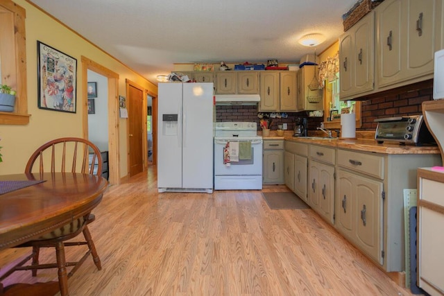 38 Greenridge Way, Jay, ME 04239 - kitchen featuring white appliances, under cabinet range hood, light wood-style floors, light countertops, and decorative backsplash