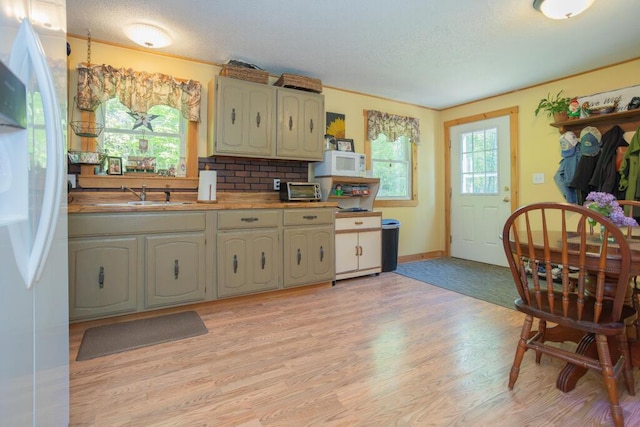 38 Greenridge Way, Jay, ME 04239 - kitchen featuring freestanding refrigerator, white microwave, a sink, light wood-style flooring, and light countertops