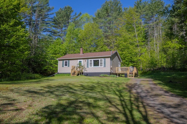 38 Greenridge Way, Jay, ME 04239 - manufactured / mobile home with a chimney, a front lawn, a wooden deck, and a wooded view
