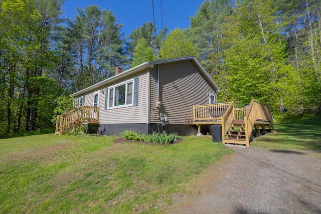 38 Greenridge Way, Jay, ME 04239 - view of home's exterior featuring a lawn, a deck, and a chimney