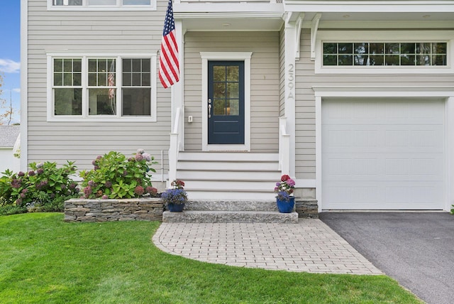 239A Foreside Rd ., Unit Falmouth, ME 04105 - entrance to property featuring a garage, asphalt driveway, and a yard
