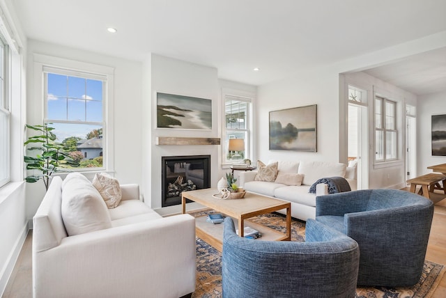 239A Foreside Rd ., Unit Falmouth, ME 04105 - living area with a glass covered fireplace, wood finished floors, recessed lighting, and baseboards