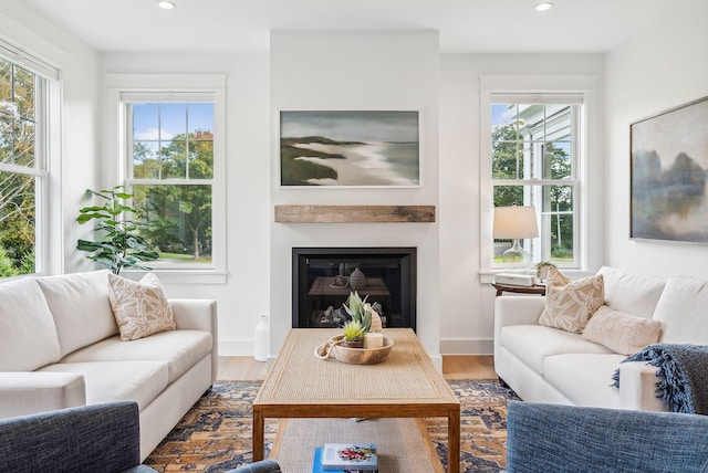 239A Foreside Rd ., Unit Falmouth, ME 04105 - living room with recessed lighting, a glass covered fireplace, wood finished floors, and baseboards