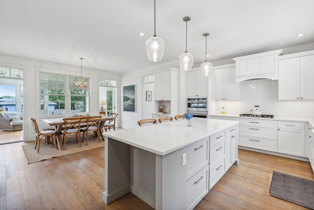 239A Foreside Rd ., Unit Falmouth, ME 04105 - kitchen featuring double oven, recessed lighting, light countertops, a center island, and gas stovetop
