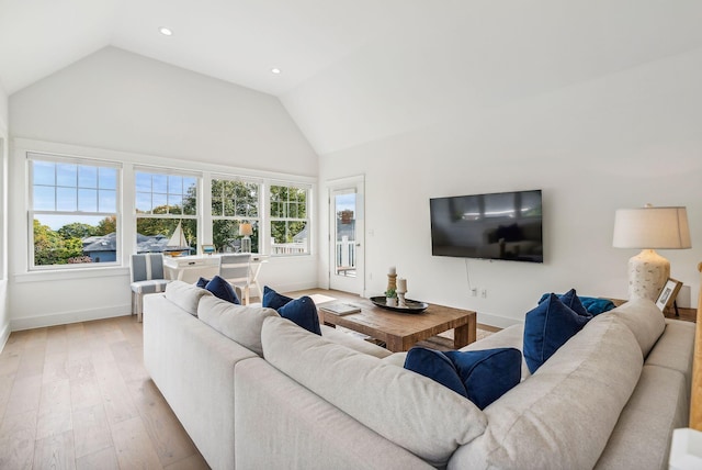239A Foreside Rd ., Unit Falmouth, ME 04105 - living area featuring baseboards, light wood finished floors, high vaulted ceiling, and recessed lighting