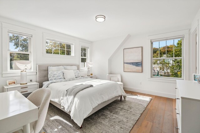 239A Foreside Rd ., Unit Falmouth, ME 04105 - bedroom featuring multiple windows, light wood finished floors, and baseboards