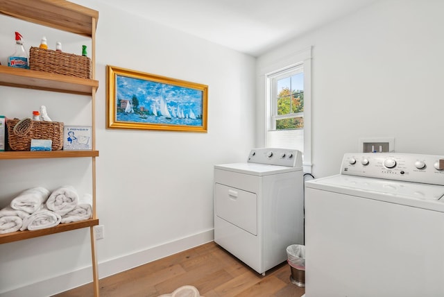 239A Foreside Rd ., Unit Falmouth, ME 04105 - washroom featuring washing machine and clothes dryer, light wood-style floors, and baseboards