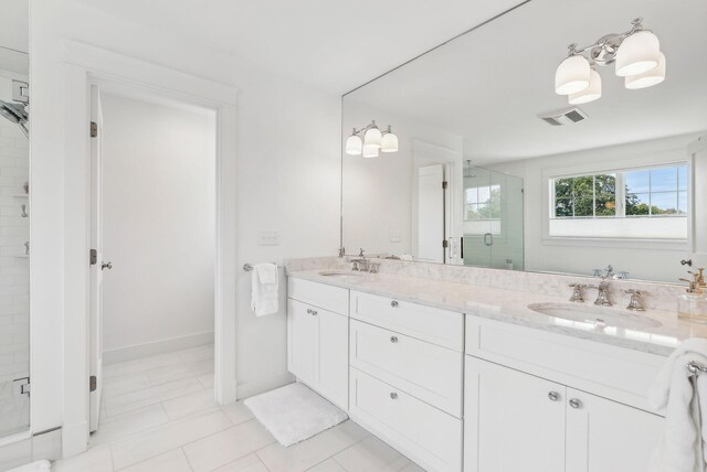 239A Foreside Rd ., Unit Falmouth, ME 04105 - bathroom with a shower stall, double vanity, baseboards, and a chandelier