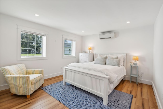 239A Foreside Rd ., Unit Falmouth, ME 04105 - bedroom with a wall mounted AC, wood finished floors, baseboards, and recessed lighting