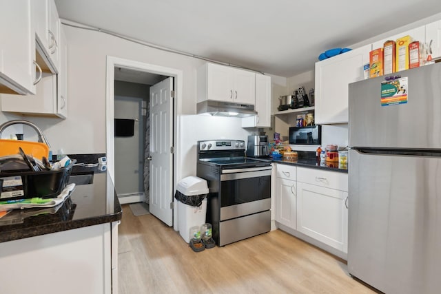 128 Alfred St, Biddeford, ME 04005 - kitchen featuring appliances with stainless steel finishes, under cabinet range hood, a baseboard radiator, white cabinetry, and light wood-type flooring