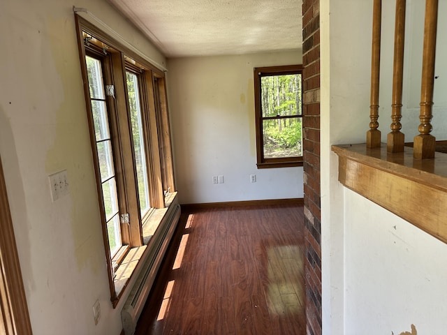 3 Harding Way, Kennebunk, ME 04043 - empty room featuring dark wood-type flooring, a textured ceiling, and baseboards