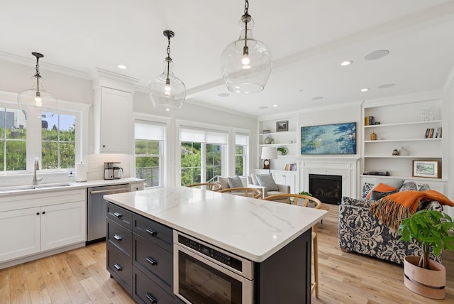 25 Benjamin Way, Portland, ME 04102 - kitchen with appliances with stainless steel finishes, a sink, white cabinets, open floor plan, and ornamental molding
