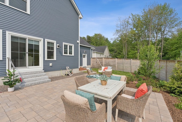 25 Benjamin Way, Portland, ME 04102 - fenced backyard featuring entry steps, a patio, and outdoor dining area