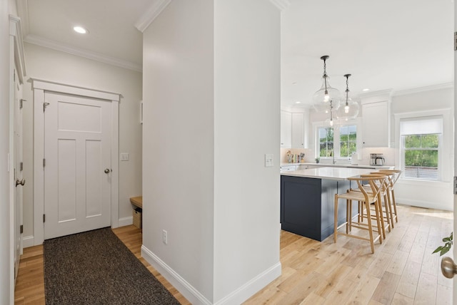 25 Benjamin Way, Portland, ME 04102 - hallway with ornamental molding, light wood-style floors, baseboards, a sink, and recessed lighting