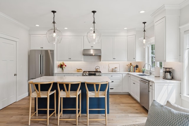 25 Benjamin Way, Portland, ME 04102 - kitchen with under cabinet range hood, a sink, appliances with stainless steel finishes, a kitchen island, and white cabinets
