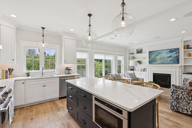 25 Benjamin Way, Portland, ME 04102 - kitchen featuring appliances with stainless steel finishes, a sink, white cabinetry, light wood-type flooring, and crown molding