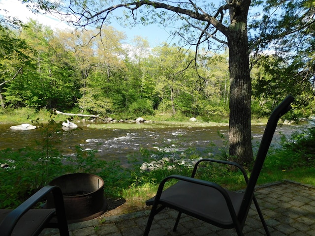 51 Pond Rd, Abbot, ME 04406 - view of patio featuring a forest view