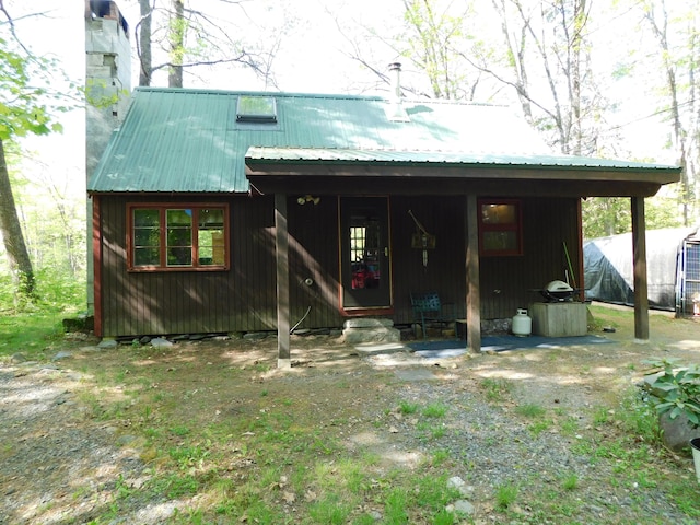 51 Pond Rd, Abbot, ME 04406 - rear view of property featuring metal roof
