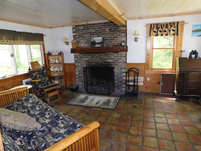 51 Pond Rd, Abbot, ME 04406 - tiled living area featuring a brick fireplace, wooden walls, a wainscoted wall, and wooden ceiling