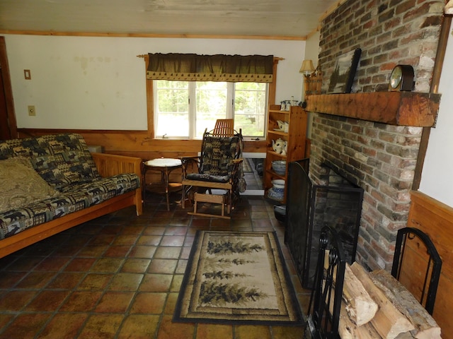 51 Pond Rd, Abbot, ME 04406 - living area featuring a brick fireplace, wainscoting, wood walls, and ornamental molding