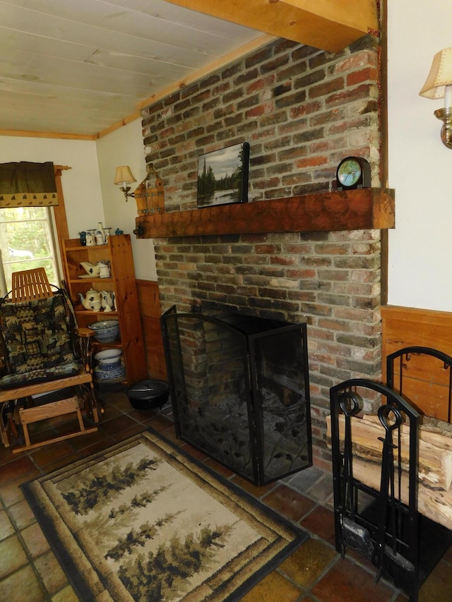 51 Pond Rd, Abbot, ME 04406 - living area featuring wainscoting, a fireplace, and stone tile flooring