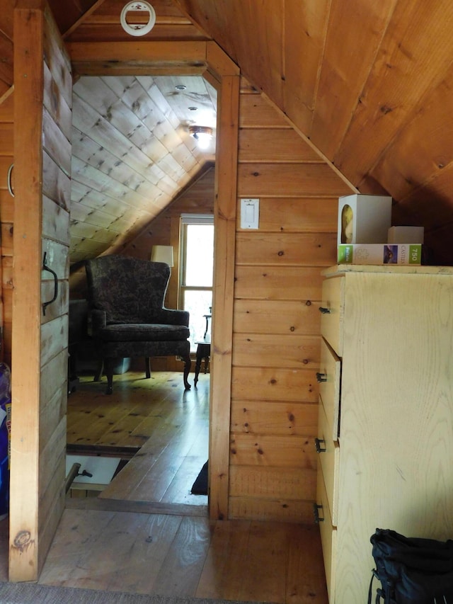 51 Pond Rd, Abbot, ME 04406 - additional living space featuring vaulted ceiling, wood walls, and wood-type flooring