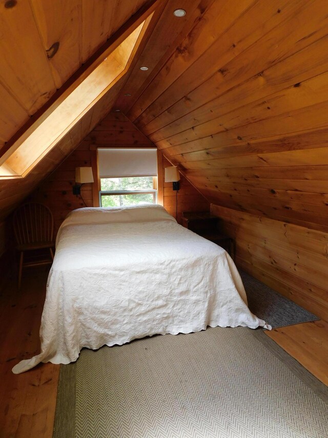 51 Pond Rd, Abbot, ME 04406 - bedroom featuring wood-type flooring, vaulted ceiling, wood ceiling, and wood walls