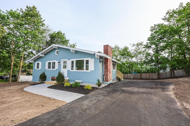 1 Knowlton Rd, Nashua, NH 03063 - view of front facade featuring a chimney and asphalt driveway
