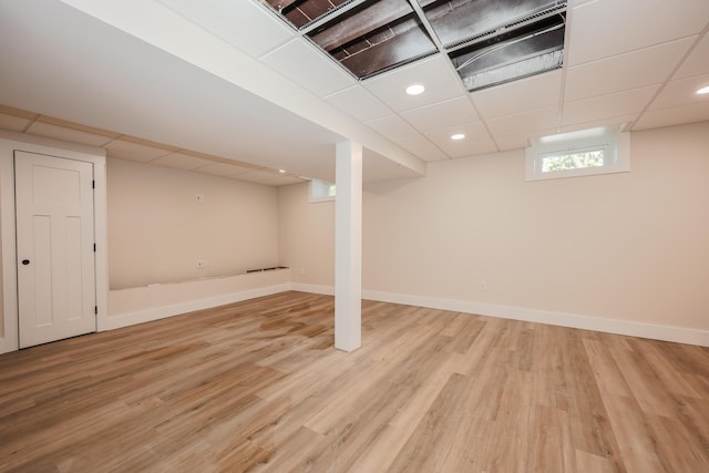 1 Knowlton Rd, Nashua, NH 03063 - basement featuring light wood finished floors, a paneled ceiling, and baseboards