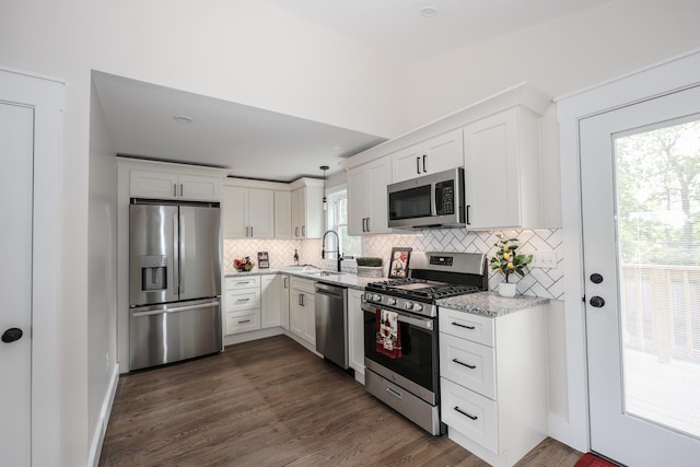 1 Knowlton Rd, Nashua, NH 03063 - kitchen with stainless steel appliances, a sink, tasteful backsplash, and white cabinets
