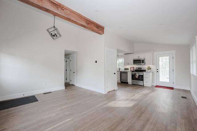1 Knowlton Rd, Nashua, NH 03063 - unfurnished living room featuring light wood-style flooring, baseboards, and high vaulted ceiling