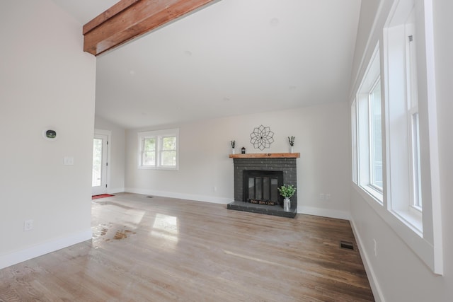 1 Knowlton Rd, Nashua, NH 03063 - unfurnished living room with light wood finished floors, a brick fireplace, and baseboards