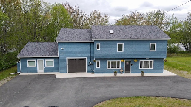 50 Water St, Howland, ME 04448 - view of front of house with driveway, an attached garage, and a shingled roof