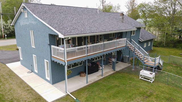 50 Water St, Howland, ME 04448 - back of property featuring roof with shingles, a patio area, a chimney, and central air condition unit