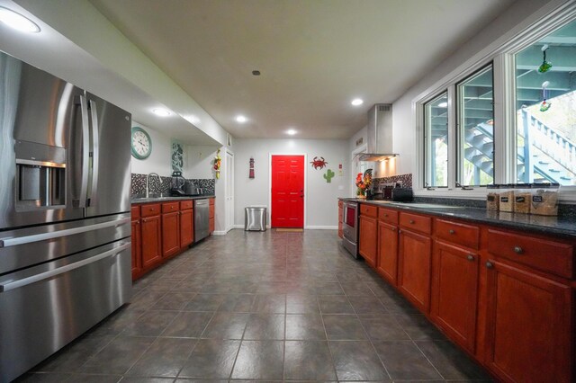 50 Water St, Howland, ME 04448 - kitchen featuring appliances with stainless steel finishes, wall chimney range hood, recessed lighting, decorative backsplash, and baseboards