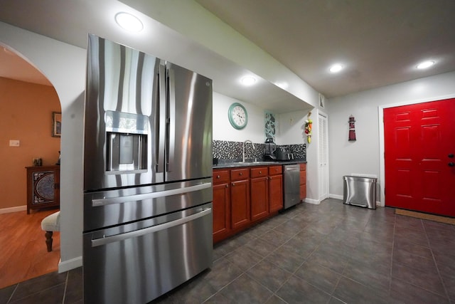 50 Water St, Howland, ME 04448 - kitchen featuring stainless steel appliances, arched walkways, dark countertops, a sink, and recessed lighting