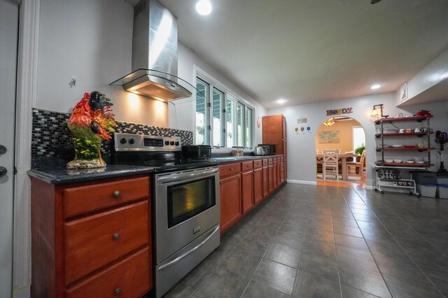 50 Water St, Howland, ME 04448 - kitchen featuring range hood, stainless steel electric range, tasteful backsplash, dark countertops, and brown cabinets
