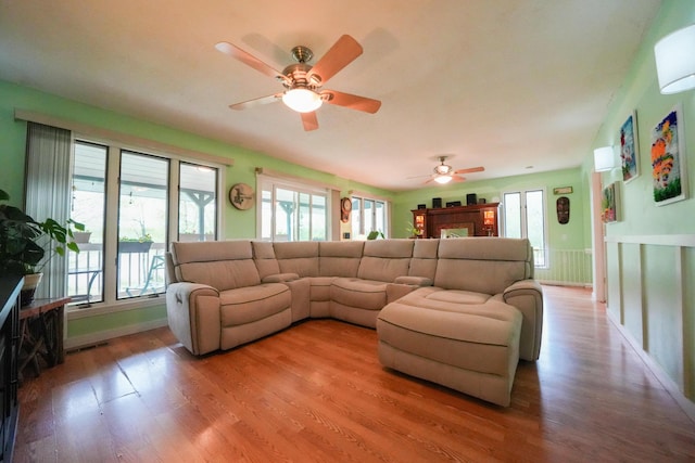 50 Water St, Howland, ME 04448 - living room featuring ceiling fan, light wood finished floors, and baseboards