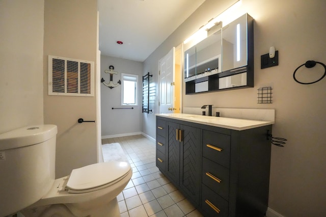 50 Water St, Howland, ME 04448 - bathroom featuring toilet, vanity, tile patterned floors, and baseboards