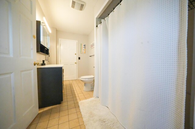 50 Water St, Howland, ME 04448 - bathroom featuring tile patterned flooring, toilet, vanity, and curtained shower