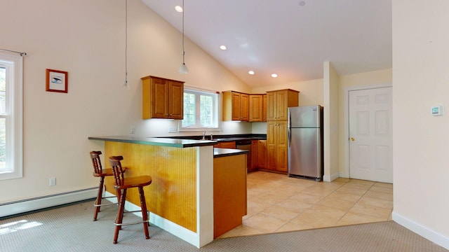 40 Acorn Ridge Rd, Freeport, ME 04032 - kitchen featuring freestanding refrigerator, a baseboard heating unit, a peninsula, brown cabinetry, and dark countertops
