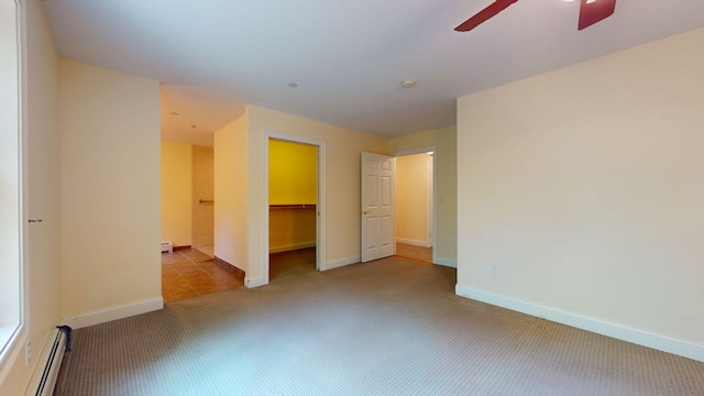40 Acorn Ridge Rd, Freeport, ME 04032 - unfurnished bedroom featuring a baseboard radiator, carpet flooring, a ceiling fan, a spacious closet, and baseboards
